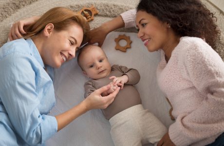 Two female parents looking at their baby