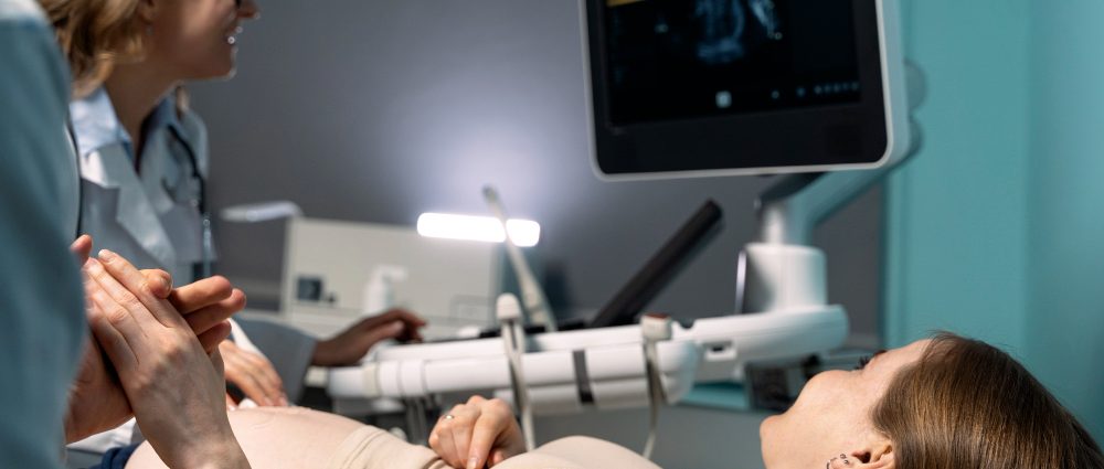 A doctor checking ultrasound of a pregnant woman.