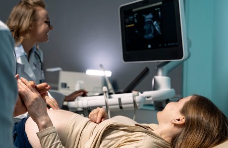 A doctor checking ultrasound of a pregnant woman.